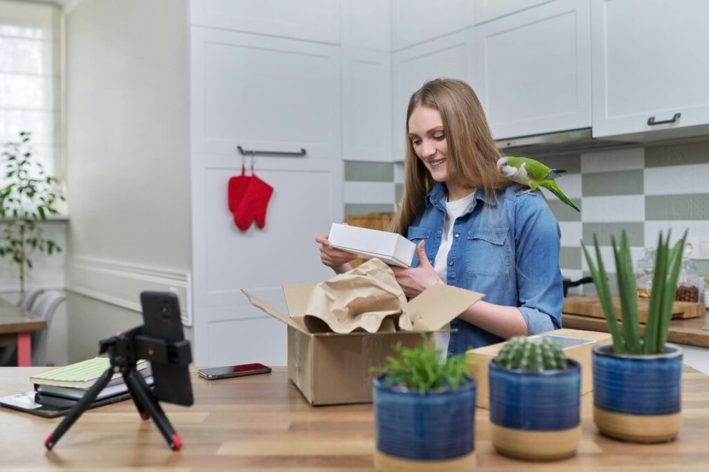 Woman recording video on smartphone unpacking